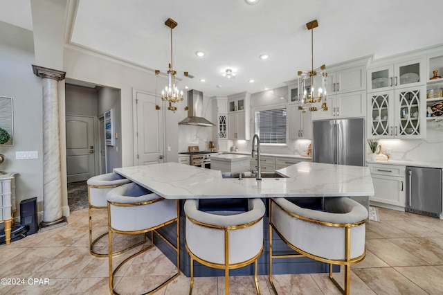 kitchen with wall chimney exhaust hood, backsplash, a large island, and stainless steel appliances