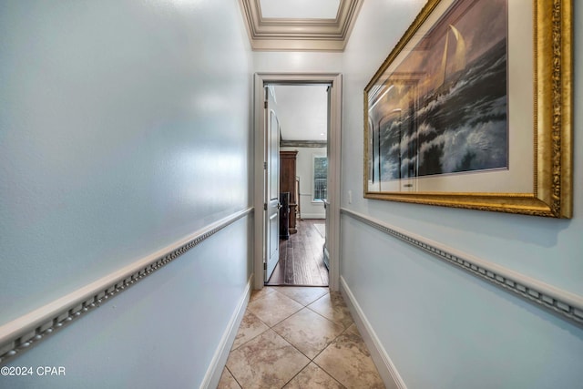 hall featuring crown molding and light tile patterned flooring