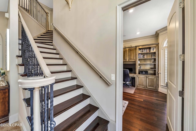 stairway featuring ornamental molding, hardwood / wood-style floors, and built in desk