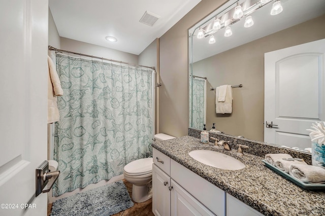 bathroom featuring vanity, toilet, and tile patterned floors