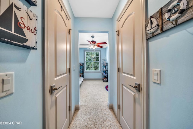 hallway featuring light carpet