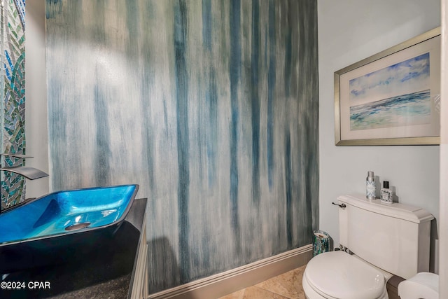 bathroom featuring toilet and tile patterned flooring