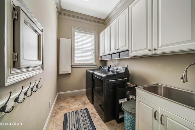 laundry room with light tile patterned floors, sink, ornamental molding, washing machine and dryer, and cabinets