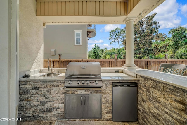 view of patio / terrace featuring sink, a grill, and an outdoor kitchen