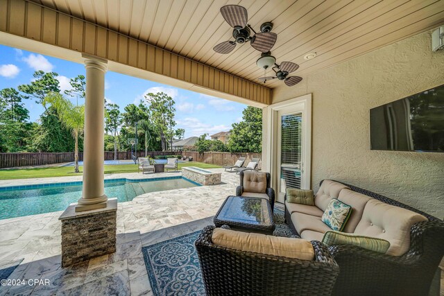 view of patio with ceiling fan, a swimming pool with hot tub, and outdoor lounge area