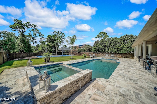 view of pool with an in ground hot tub, a patio, and a lawn