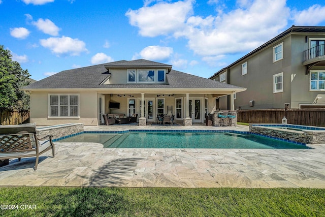 view of pool featuring an in ground hot tub, a patio area, and ceiling fan