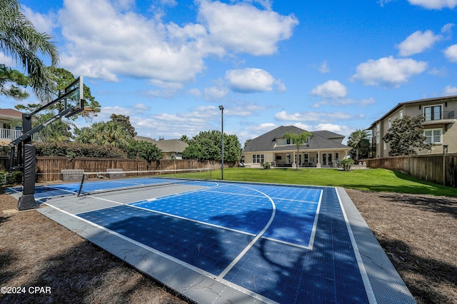 view of sport court with a lawn and tennis court