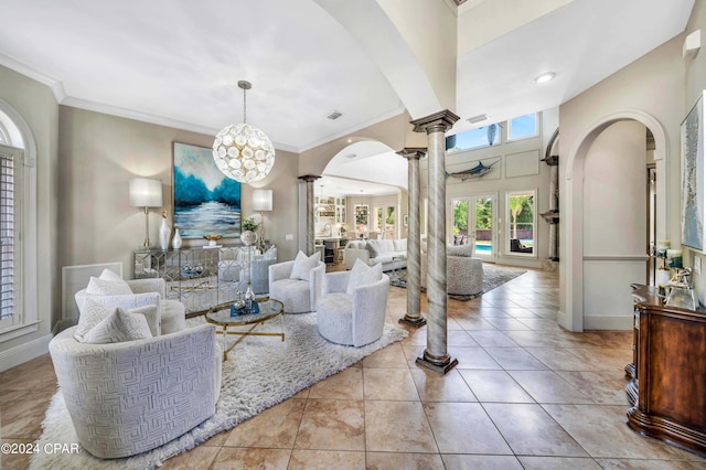 tiled living room with ornate columns, an inviting chandelier, and crown molding