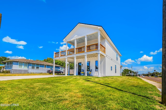 back of property featuring a lawn and a balcony