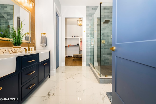 bathroom featuring vanity and a shower with door