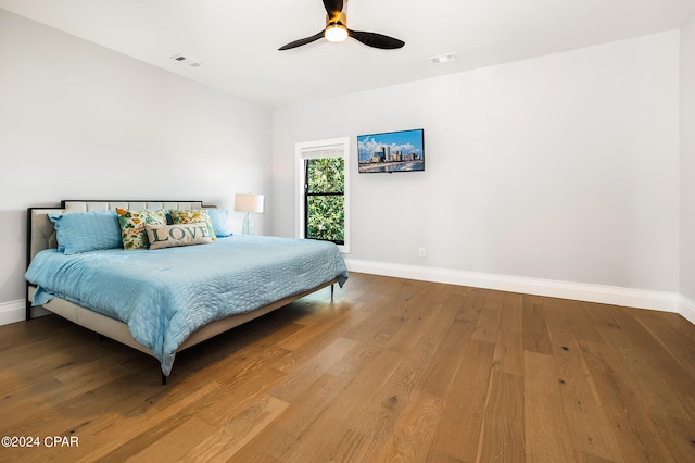 bedroom with ceiling fan and hardwood / wood-style flooring