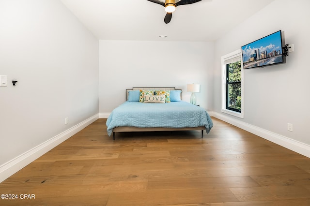 bedroom with wood-type flooring and ceiling fan