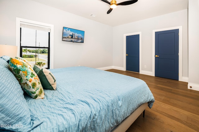 bedroom featuring ceiling fan and dark wood-type flooring