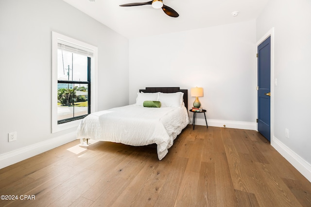 bedroom with wood-type flooring and ceiling fan