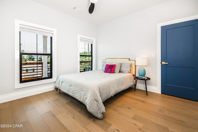 bedroom with ceiling fan and light hardwood / wood-style flooring