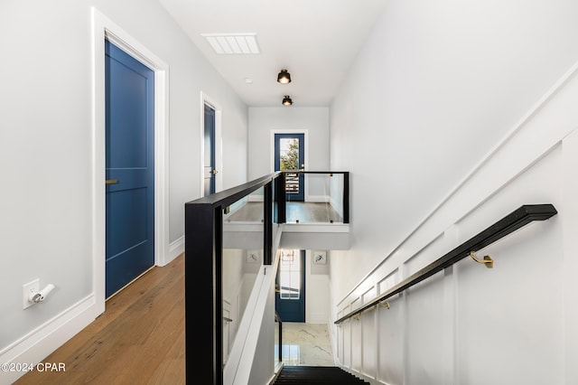 stairs with hardwood / wood-style flooring