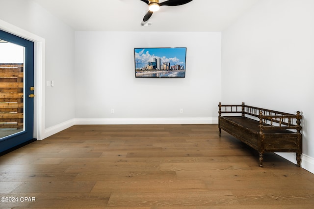 sitting room with ceiling fan and hardwood / wood-style flooring