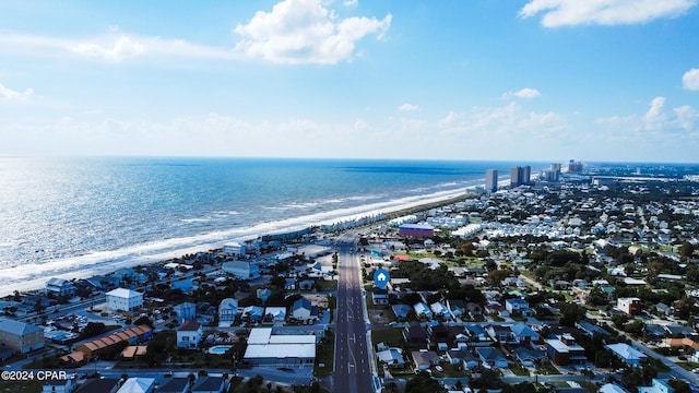 birds eye view of property featuring a water view and a beach view