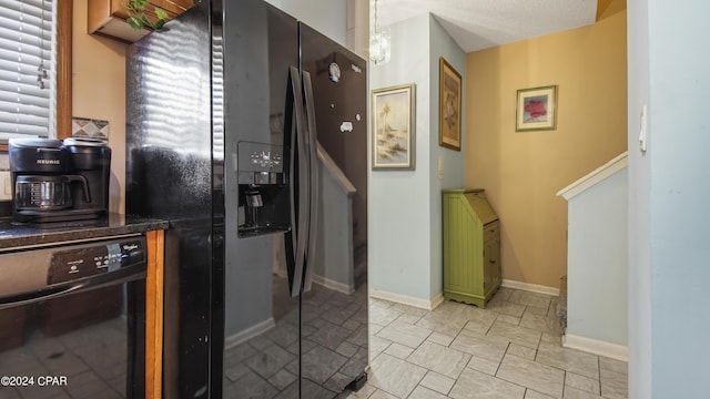 kitchen featuring dark countertops and black appliances