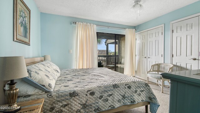 carpeted bedroom featuring access to outside, a textured ceiling, and ceiling fan