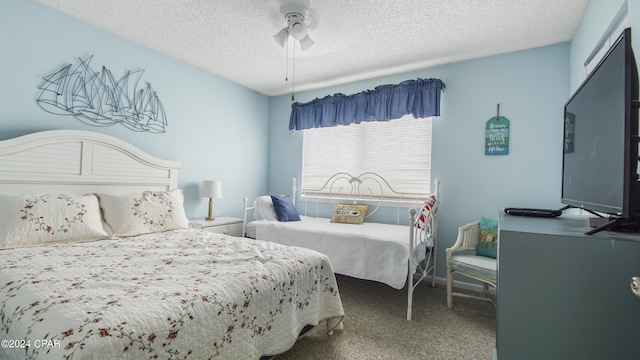 carpeted bedroom with a textured ceiling and a ceiling fan