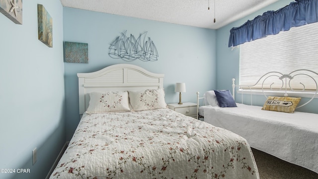 bedroom featuring carpet flooring and a textured ceiling