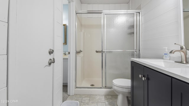 full bath featuring vanity, a shower stall, and toilet