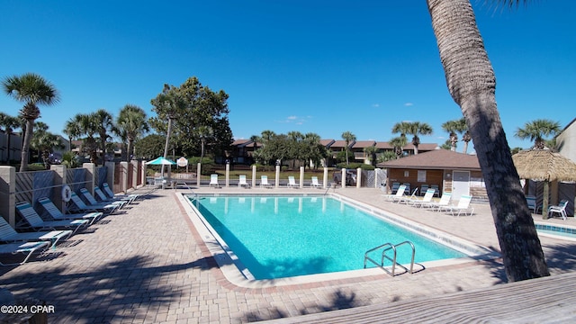 community pool featuring fence and a patio