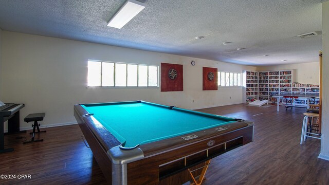 recreation room with a textured ceiling, billiards, a wealth of natural light, and dark hardwood / wood-style floors