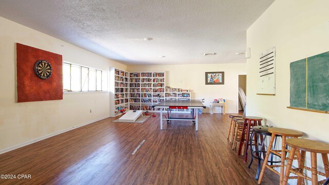 interior space featuring dark wood-type flooring and a textured ceiling