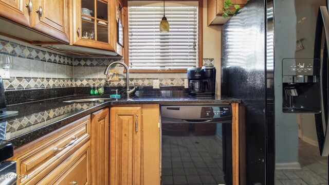 kitchen featuring dark stone counters, sink, tasteful backsplash, black fridge with ice dispenser, and wine cooler