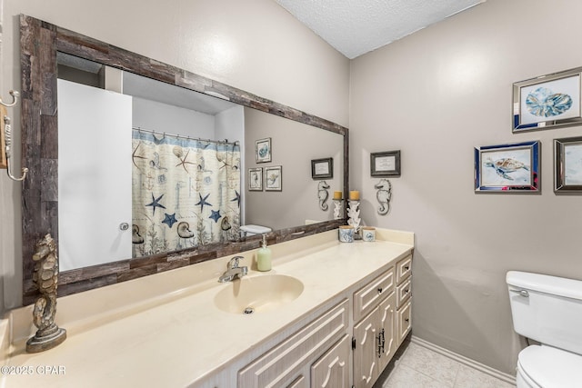 bathroom featuring tile patterned flooring, vanity, a textured ceiling, and toilet