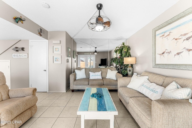 living room featuring light tile patterned floors and french doors