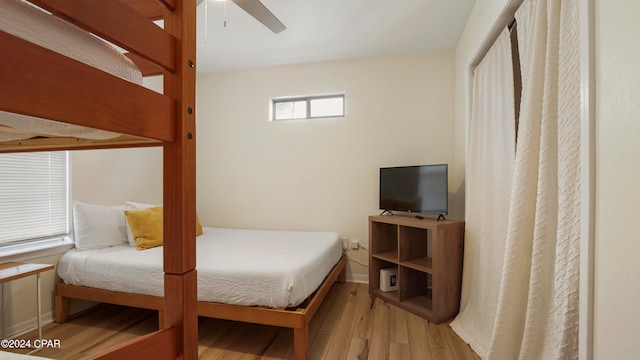 bedroom with ceiling fan and light hardwood / wood-style floors