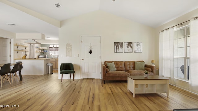 3809 Mystic St, Panama City, FL 32408 - living area featuring light wood-type flooring, vaulted ceiling, and visible vents