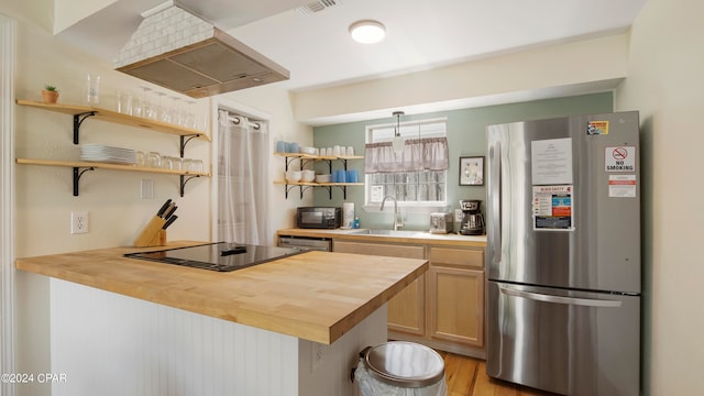 kitchen with light wood-type flooring, butcher block counters, sink, custom exhaust hood, and appliances with stainless steel finishes