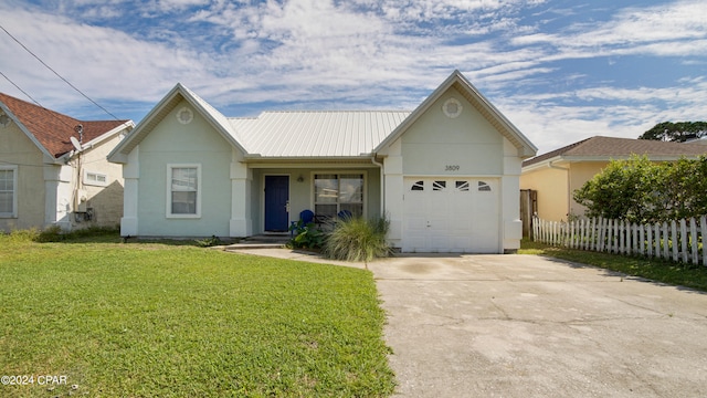 view of front facade with a front yard and a garage