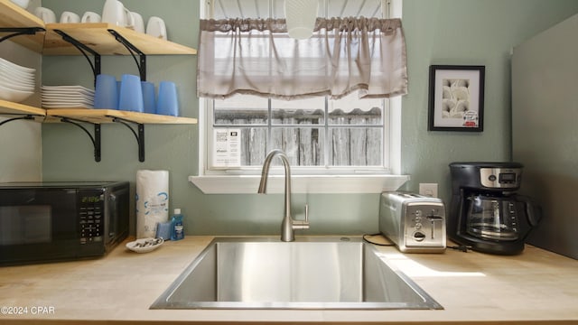 3809 Mystic St, Panama City, FL 32408 - room details with open shelves, black microwave, light countertops, and a sink