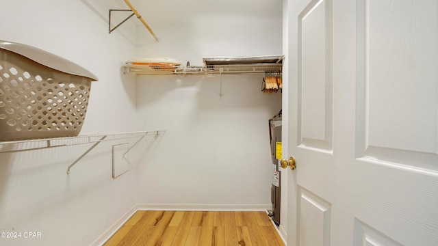 walk in closet with light wood-type flooring