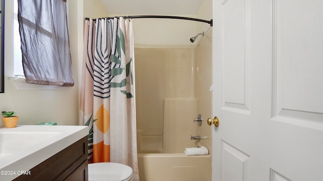 full bathroom featuring vanity, shower / bath combo with shower curtain, and toilet