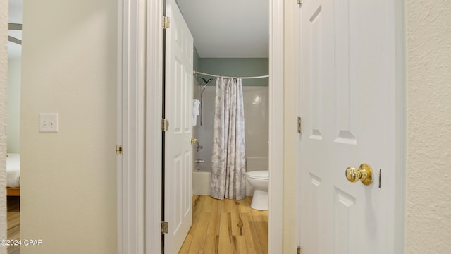 3809 Mystic St, Panama City, FL 32408 - bathroom featuring wood finished floors, toilet, and shower / bathtub combination with curtain