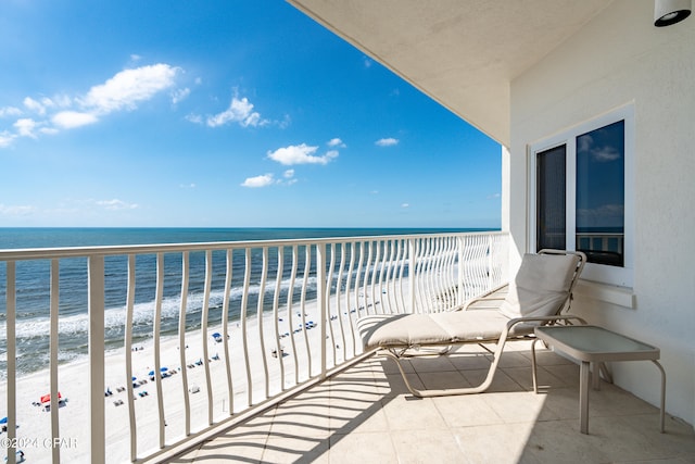 balcony with a view of the beach and a water view