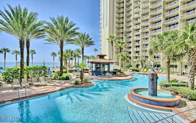 view of swimming pool with a patio, a water view, and a gazebo