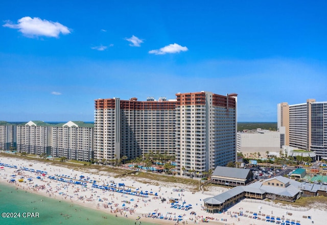 view of building exterior with a view of the beach and a water view