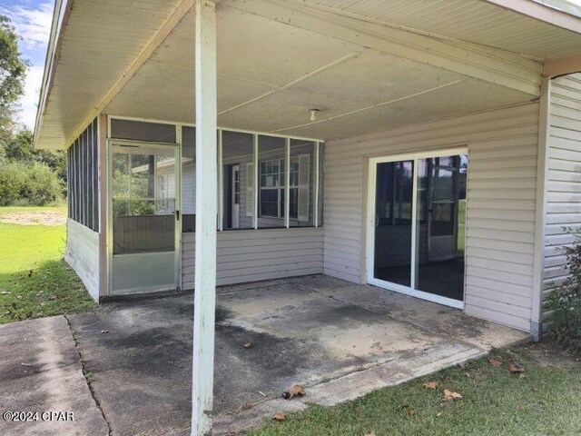 view of patio featuring a sunroom