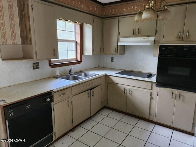 kitchen with black appliances, cream cabinets, sink, and light tile patterned floors