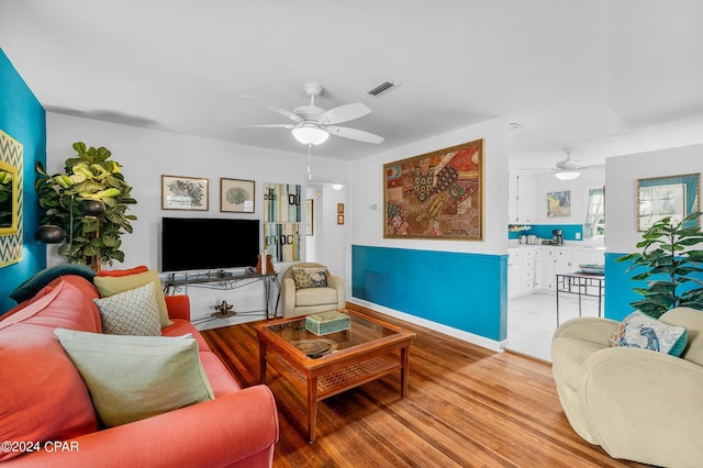 living room featuring light hardwood / wood-style floors and ceiling fan