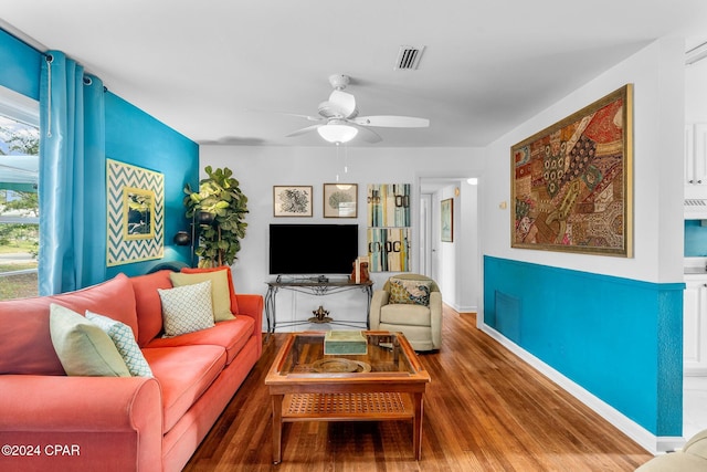 living room featuring wood-type flooring and ceiling fan