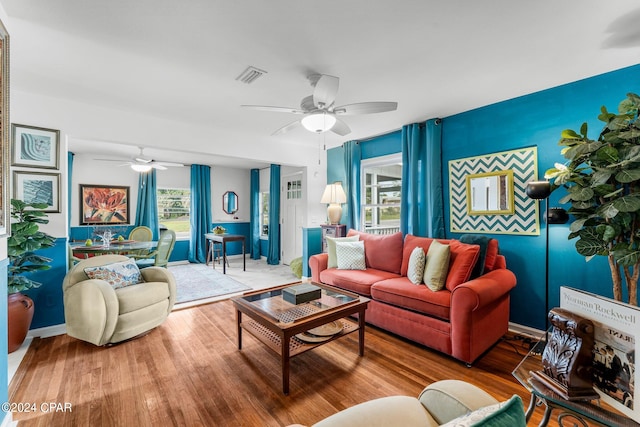 living room featuring ceiling fan and wood-type flooring